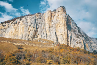 Low angle view of rock formation against sky