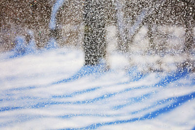 Close-up of water splashing against blue sky