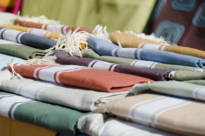 Close-up of multi colored towels on table for sale