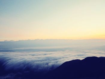 Scenic view of mountains against sky at sunset