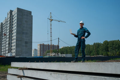 Low angle view of man standing on street against clear sky