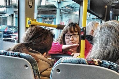 Rear view of woman sitting in train