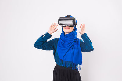 Rear view of woman standing against white background