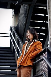 Low angle view of woman standing on staircase