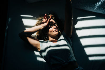 High angle view of woman relaxing on bed at home