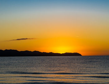 Scenic view of sea against orange sky