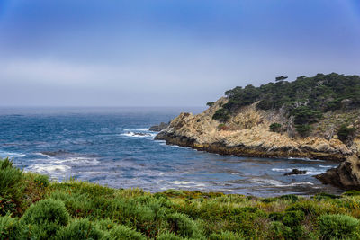 Scenic view of beach and sea against clear sky