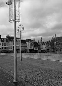 Street lights in city against sky