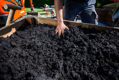 Midsection of man gardening in yard