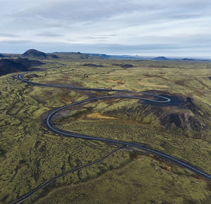 Green valley with curvy road