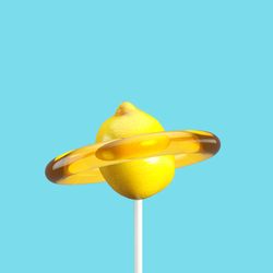 Close-up of lemon candy against blue background