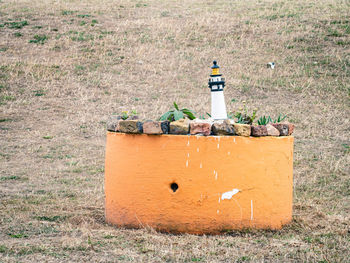 Model of lighthouse in orange flower pot