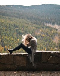 Woman on stone wall