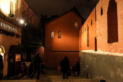 Men on illuminated street at night