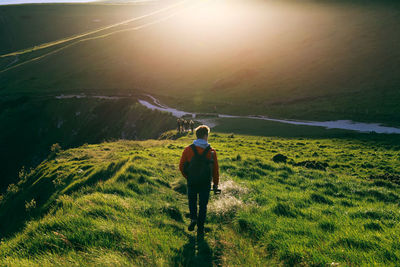 Rear view of man walking on mountain