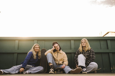 Portrait of teenage girls with skateboards