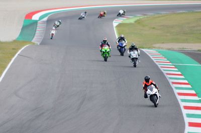 High angle view of people riding motorcycle on road