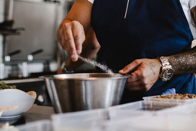 Midsection of man preparing food