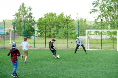 People playing soccer on field