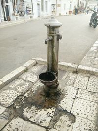 Close-up of faucet in city