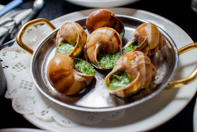 Close-up of snails in plate on table