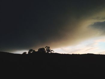 Silhouette landscape against sky at sunset