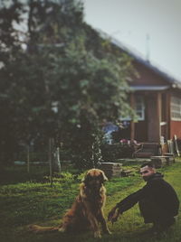 Man with dog against plants