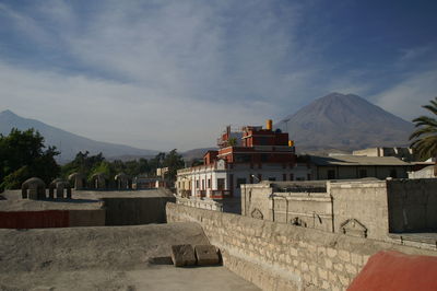 Panoramic view of buildings and mountains against sky