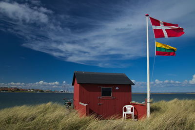 Lifeguard hut on beach against sky