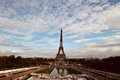 Tower of building against cloudy sky