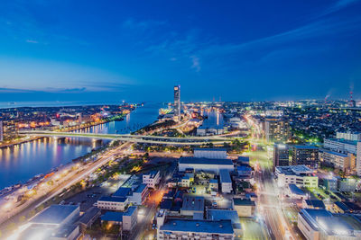 High angle view of city lit up at night