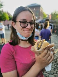 Portrait of young woman eating food