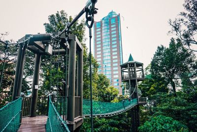 Low angle view of trees and buildings against sky