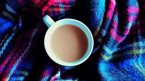 Directly above shot of tea cup, cozy with blanket background 