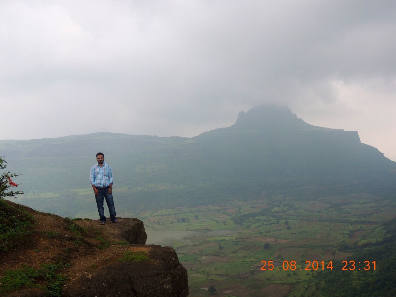 mountain, lifestyles, leisure activity, rear view, sky, landscape, mountain range, tranquility, men, tranquil scene, full length, scenics, rock - object, casual clothing, hiking, nature, beauty in nature, standing