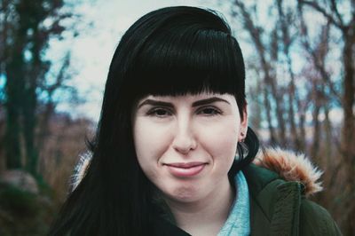 Portrait of young woman against sky