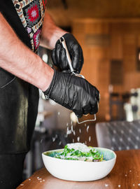 Midsection of chef preparing food in restaurant