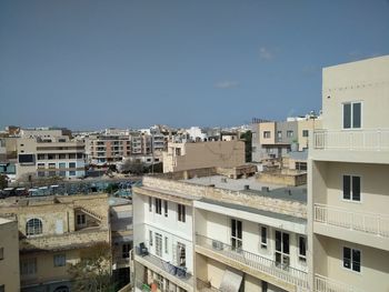 Houses in city against clear sky