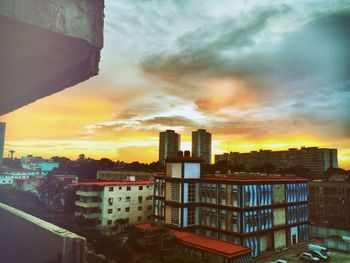 Buildings in city at sunset