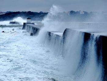 Sea waves splashing on retaining wall