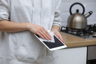 Midsection of man using mobile phone