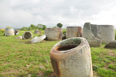 Stone structure on field against sky