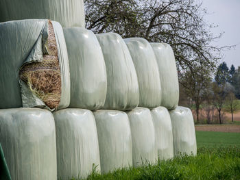 Stack of hay bales on field