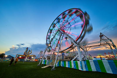 Low angle view of ferris wheel against sky