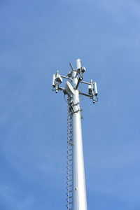 Low angle view of telephone pole against sky