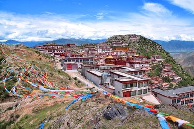 High angle view of houses in town against sky
