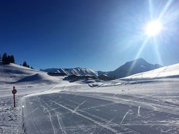 Scenic view of landscape against clear sky during winter