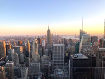 Aerial view of buildings in city during sunset