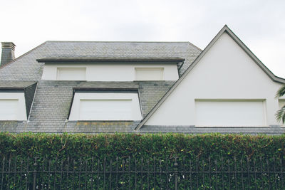 Low angle view of house and building against sky