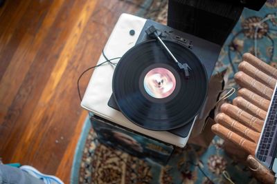 Overhead view of retro vinyl record spins on turntable bohemian room